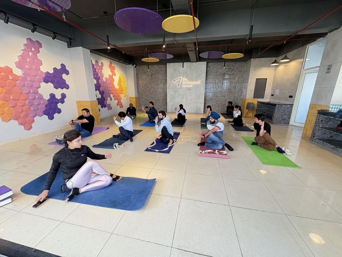 Colleagues in a group yoga session in the office wellness room