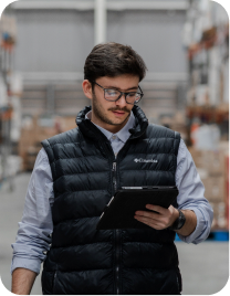 Warehouse worker reviewing a delivery on a tablet